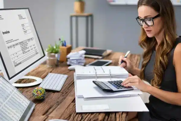 Professional Malta tax accountant reviewing documents in an office